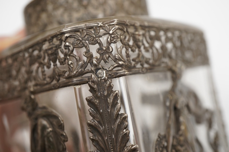 A late 19th/early 20th century French 800 standard pierced white metal mounted glass jar or tea caddy and stopper, decorated with classical scene of a lady with child, height 13.2cm.